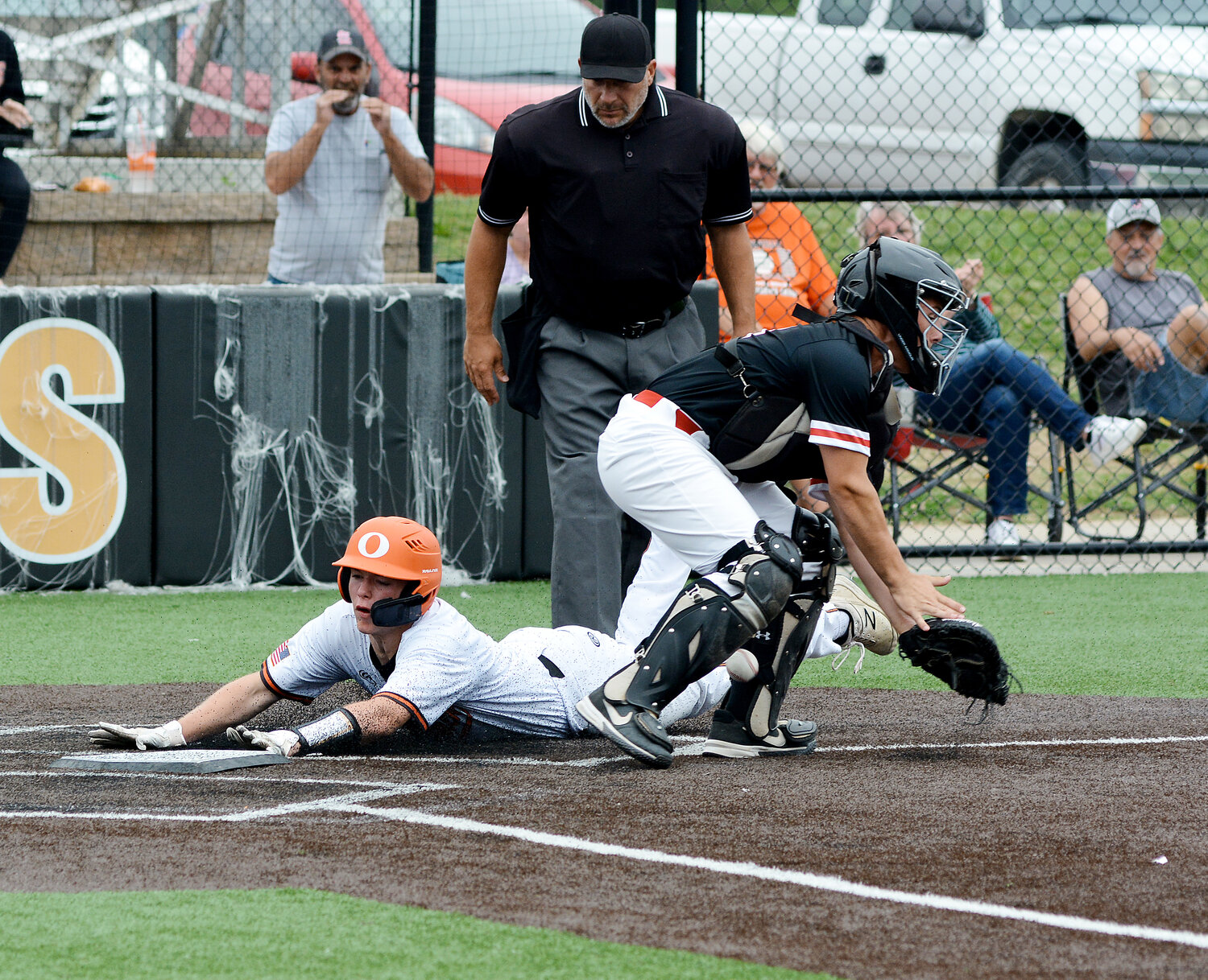Landon Kramme slides safely into home while the baseball gets by St. James catcher Travis Hall during the top of the second inning of Owensville’s 6-4 district-semifinal loss to the Tigers at OHS Field. Sullivan won the other semifinal over Salem 8-2 and will face St. James tomorrow (Thursday) at 4 p.m., in the Missouri State High School Activities Association (MSHSAA) Class 4, District 4 championship game.